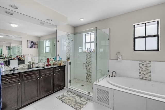 bathroom with separate shower and tub, vanity, and tile patterned floors