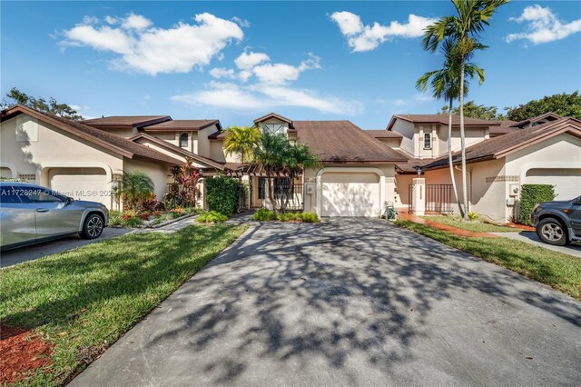 view of front of property featuring a garage and a front yard