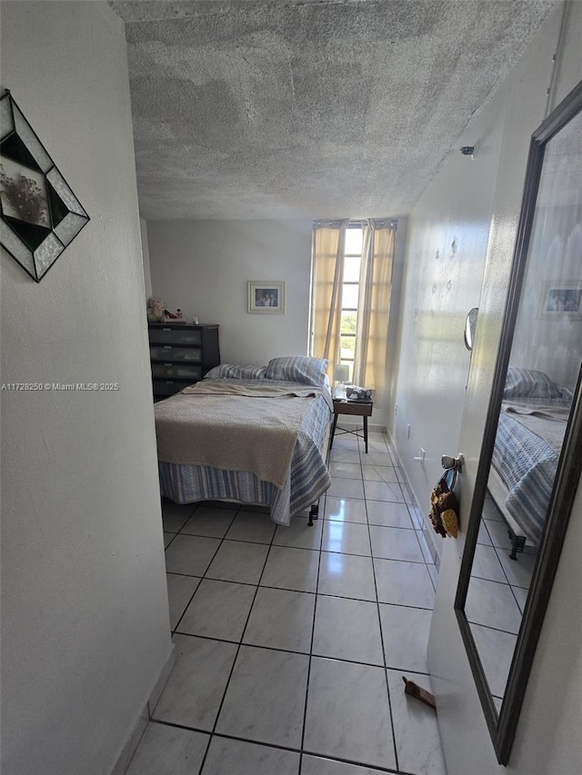 unfurnished bedroom with light tile patterned flooring and a textured ceiling
