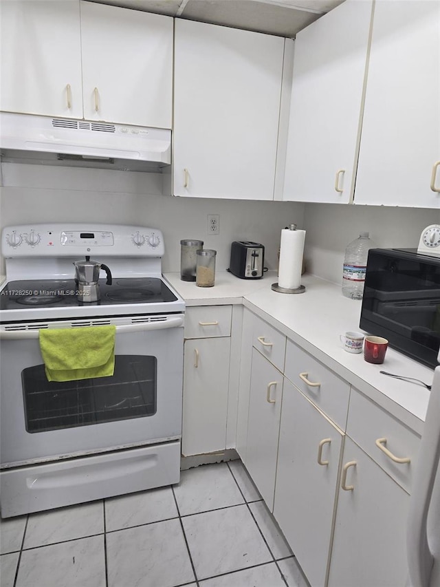 kitchen featuring white cabinetry, light tile patterned floors, and white electric range