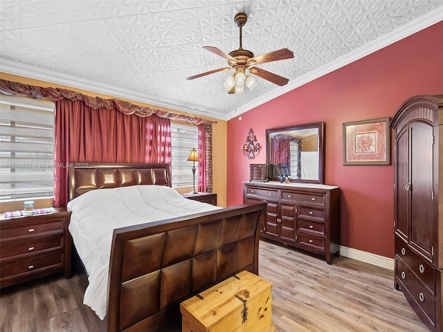 bedroom featuring ceiling fan, wood-type flooring, crown molding, and lofted ceiling