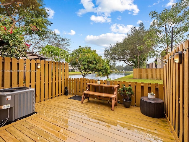 wooden terrace with cooling unit and a water view