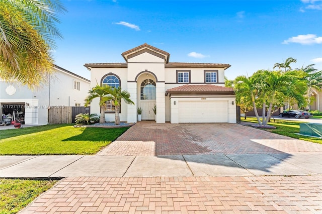 mediterranean / spanish-style house with a front lawn and a garage