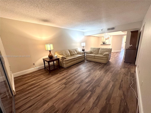 unfurnished living room with dark hardwood / wood-style floors and a textured ceiling