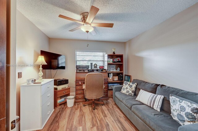 office with a textured ceiling, light hardwood / wood-style flooring, and ceiling fan