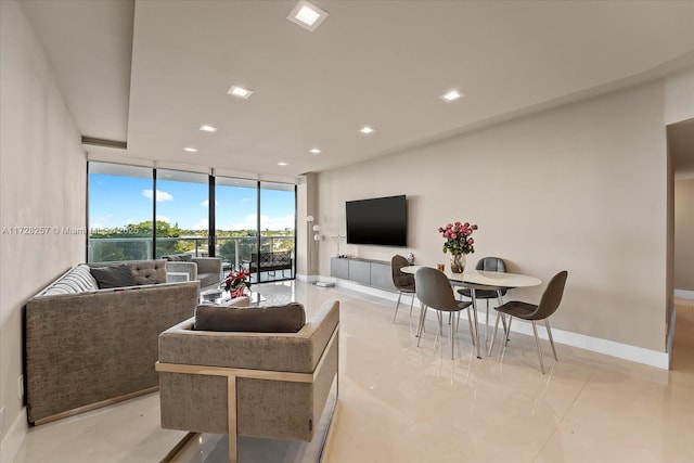 living room with floor to ceiling windows and light tile patterned floors