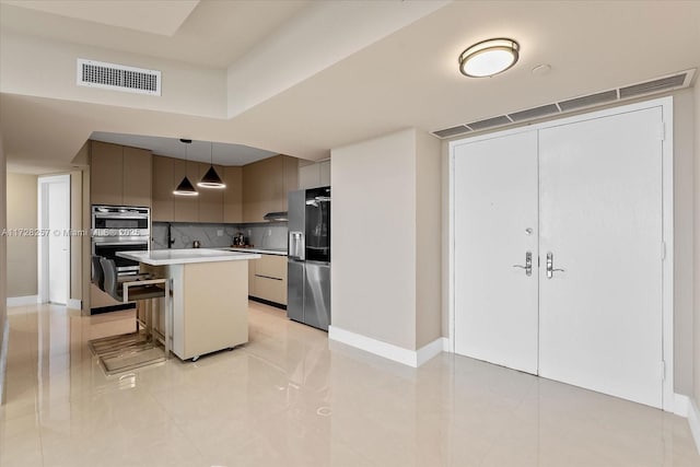 kitchen with stainless steel appliances, tasteful backsplash, decorative light fixtures, a kitchen breakfast bar, and a center island