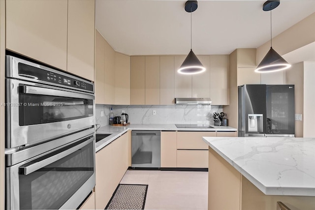 kitchen with pendant lighting, black appliances, decorative backsplash, light stone countertops, and cream cabinets