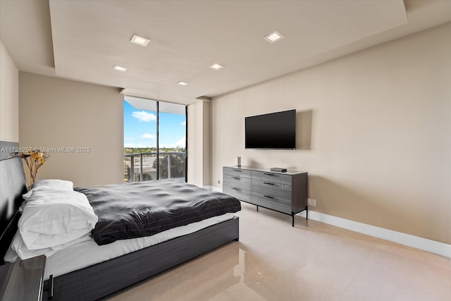 bedroom featuring a wall of windows and access to exterior