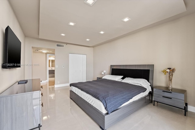 bedroom with a closet and light tile patterned flooring