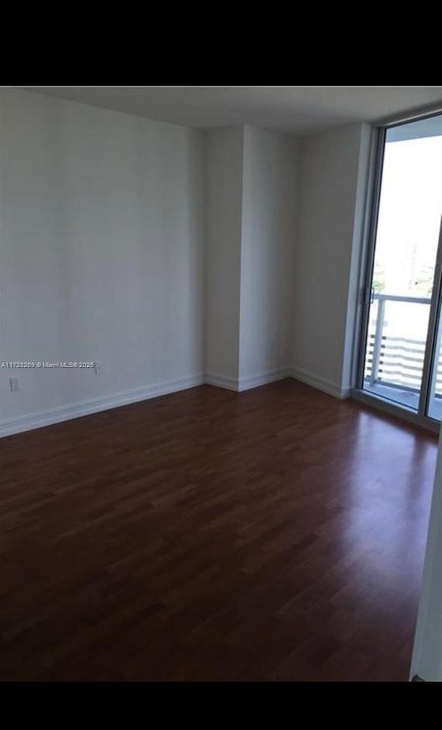 spare room with dark hardwood / wood-style flooring