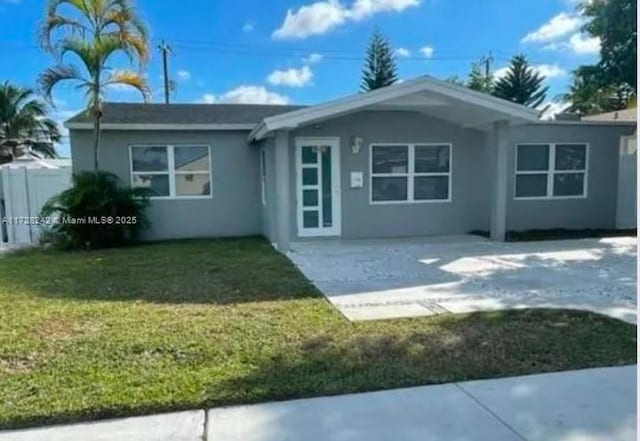 rear view of property with a lawn