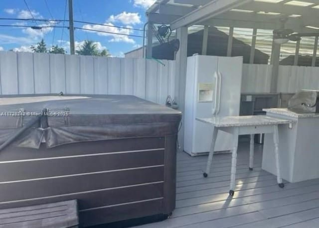 deck featuring a hot tub