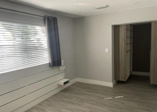 spare room with wood-type flooring