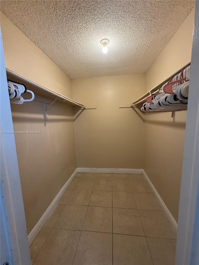 walk in closet featuring tile patterned flooring