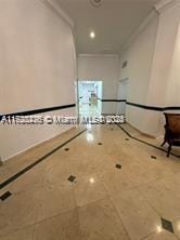 hallway featuring crown molding and tile patterned flooring