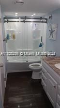 full bathroom with toilet, shower / bathing tub combination, and vanity