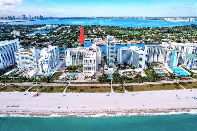 bird's eye view with a water view, a view of city, and a beach view