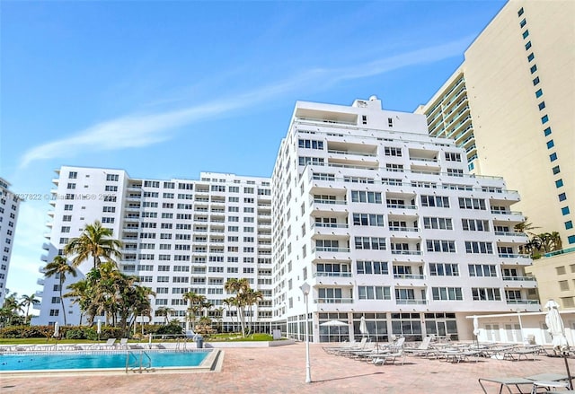 view of building exterior featuring a community pool