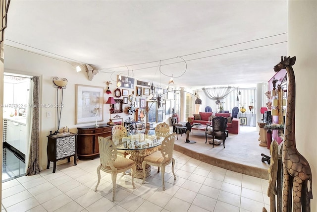 dining room featuring light tile patterned floors and light colored carpet