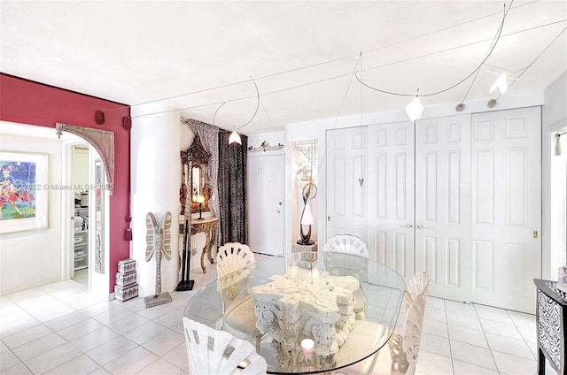 dining room with arched walkways and light tile patterned floors