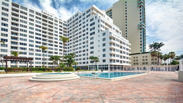 community pool with a patio and a pergola