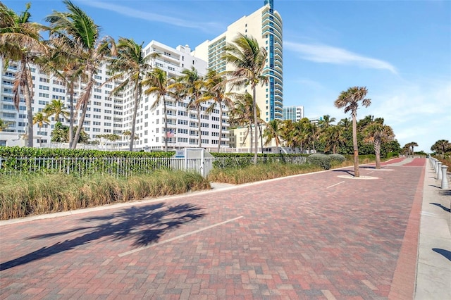 view of building exterior with a city view and fence