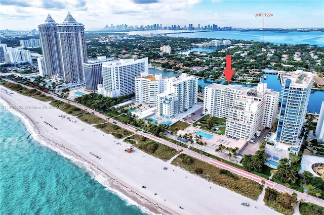 drone / aerial view with a view of city, a water view, and a view of the beach