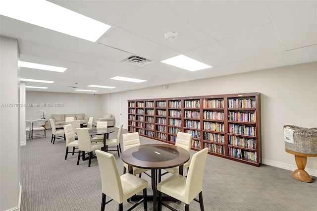 dining space featuring visible vents, carpet floors, a paneled ceiling, and baseboards