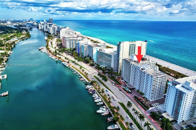 drone / aerial view featuring a water view and a view of city