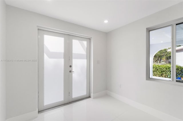 entryway with french doors and light tile patterned flooring