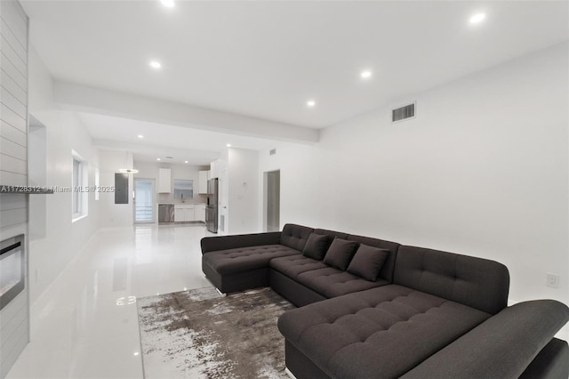 tiled living room with sink and a fireplace