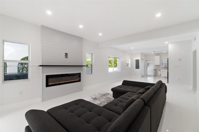 living room featuring beam ceiling and sink