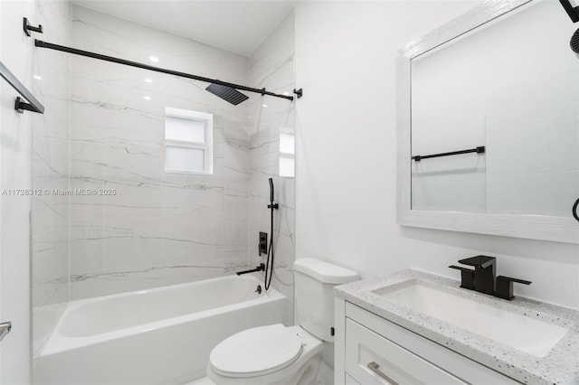 full bathroom featuring toilet, vanity, and tiled shower / bath