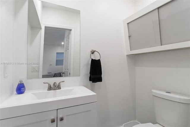 bathroom with toilet and vanity