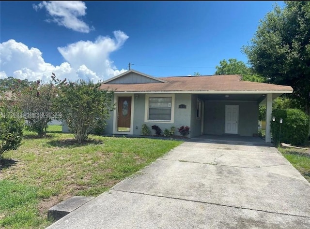 ranch-style home with a front lawn and a carport