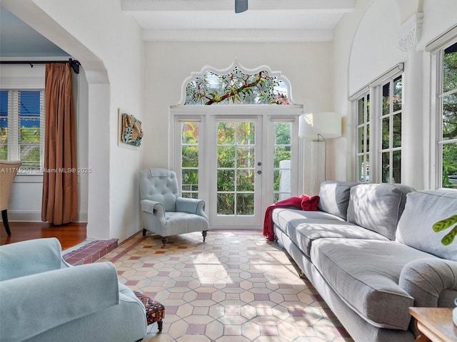 sunroom / solarium featuring beam ceiling