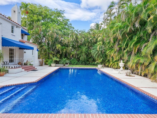 view of swimming pool featuring a patio area