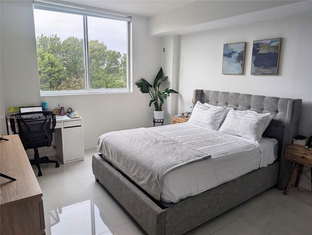 bedroom with light tile patterned floors