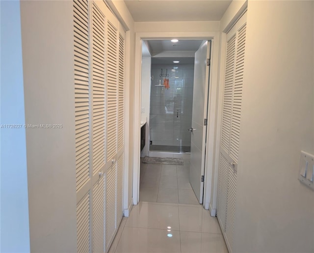 hallway with tile patterned flooring