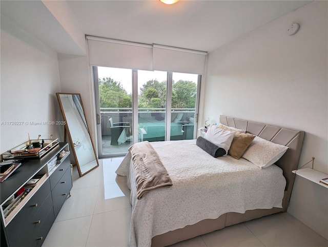 bedroom featuring light tile patterned flooring, floor to ceiling windows, and access to outside