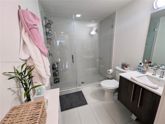 full bath featuring tile patterned flooring, vanity, a shower stall, and toilet