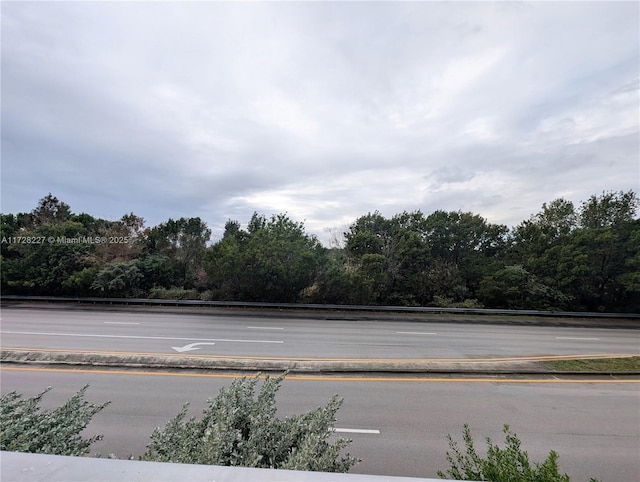 view of road featuring a wooded view