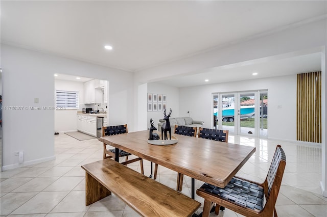 dining room featuring light tile patterned floors, french doors, and beverage cooler