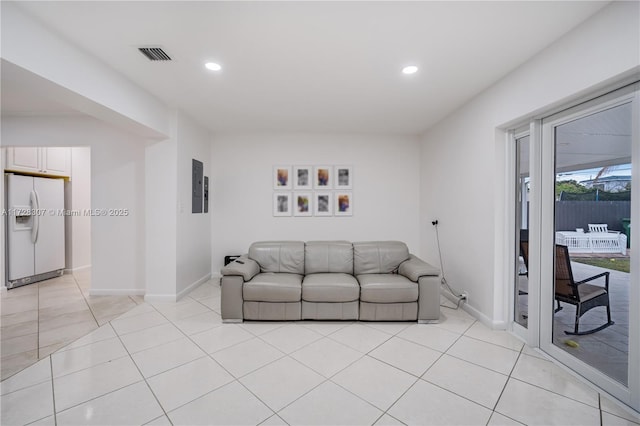 living room with light tile patterned floors and electric panel