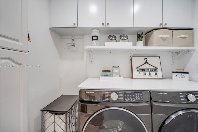 clothes washing area with cabinets and washing machine and dryer