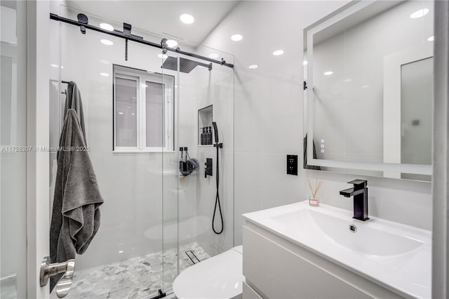 bathroom with toilet, walk in shower, and vanity