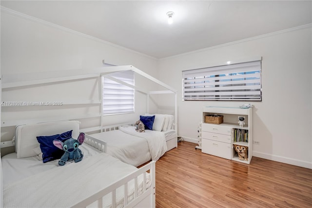 bedroom with ornamental molding and hardwood / wood-style floors