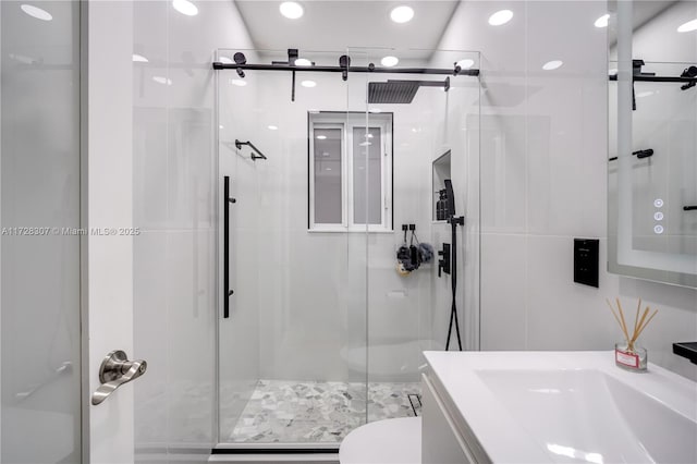 bathroom with toilet, an enclosed shower, and vanity