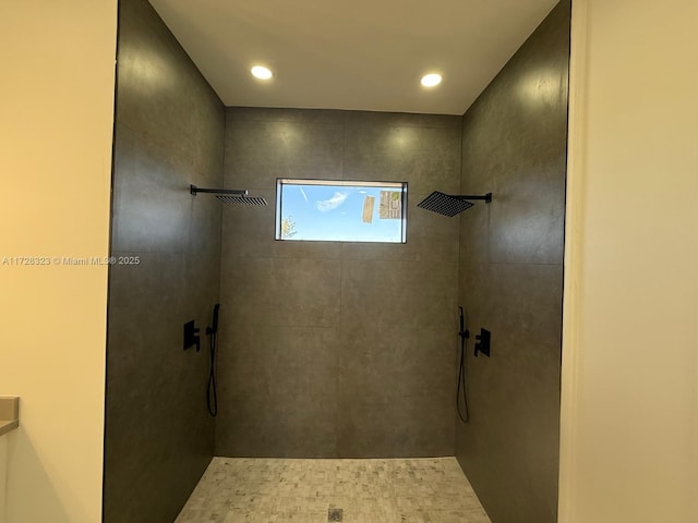 bathroom with a tile shower